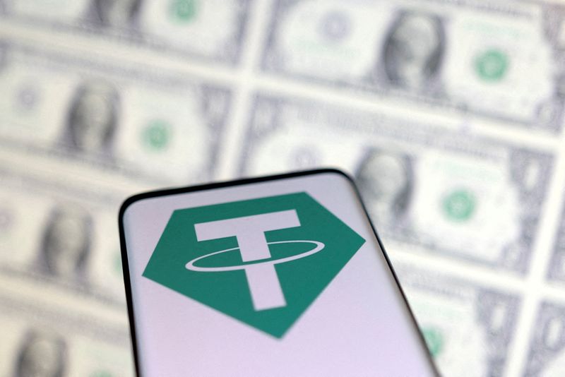 FILE PHOTO: Illustration shows Tether logo and U.S. dollars
